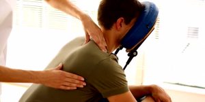 Man getting a massage in a chair in therapy room